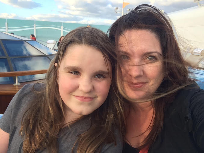 My youngest and I doing our favorite thing on a cruise ship - being up top and enjoying the wind.