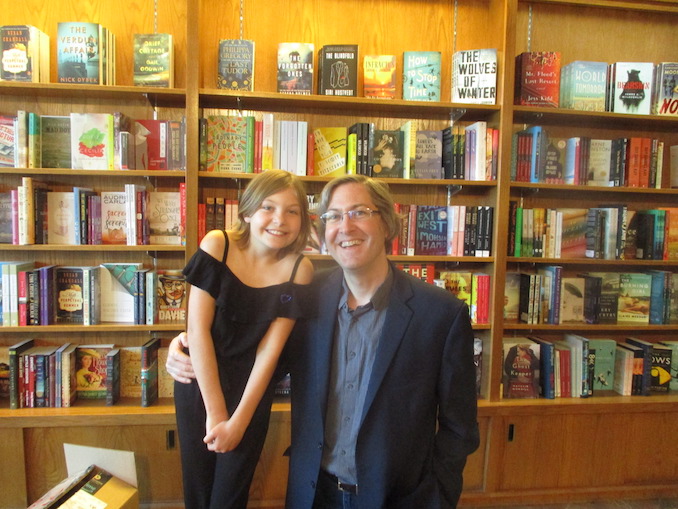 Craig DiLouie with his daughter Mieka at her book signing at the Owl’s Nest bookstore Craig challenged her that if she wrote a book, he’d publish it. Her novel, She Tamed a Dragon, was on the Calgary Herald bestseller list for several weeks. All profits were donated to Inn from the Cold, a local charity that helps families in need.