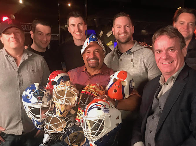 Team wrap photo with NHL legend Grant Fuhr holding most of his old NHL masks