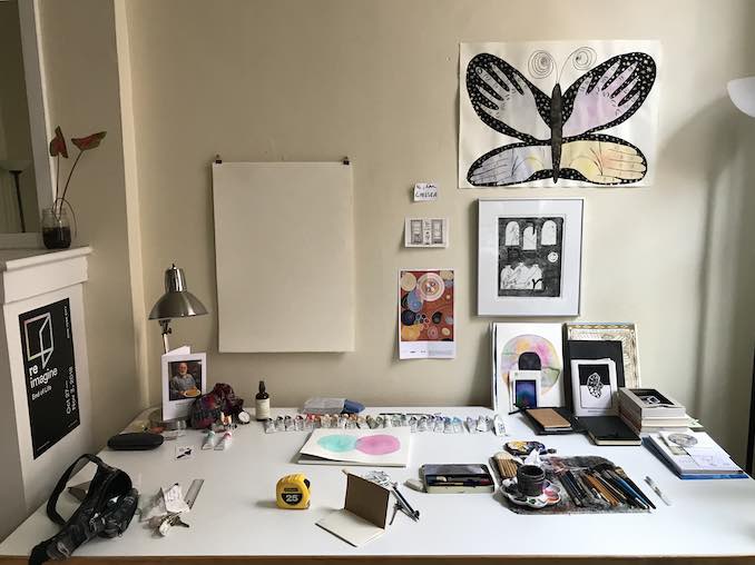 My studio table / Portrait of my brain (featuring, in the top right, Rainbow Butterfly, gouache and graphite on paper, 18" x 24", 2018).