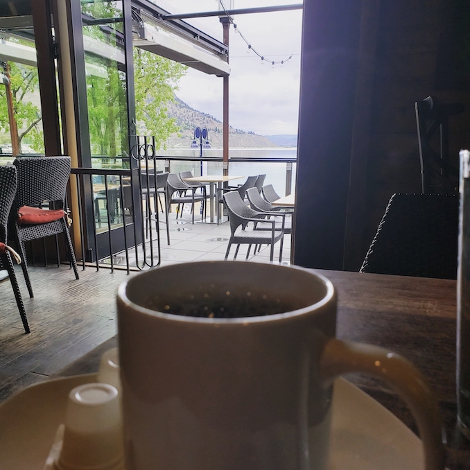 I am always on the road doing comedy ... I try to take advantage of the scenery in each town and write a little every chance I get . Coffee and a view of the Okanogan on this particular day in the beautiful Penticton British Columbia