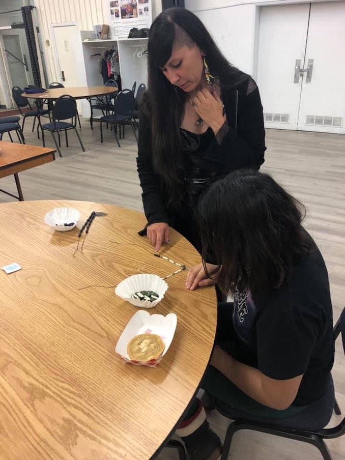 Teaching urban Indigenous youth how to make hairpipe necklaces.