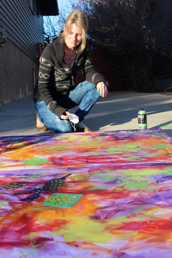 Spray painting (or air brushing) is done outside, which can also be done in my garage, but I prefer to work in sunshine so several canvases are coated with layers of colour throughout my week and then the stencil work can be added on a good weather day.