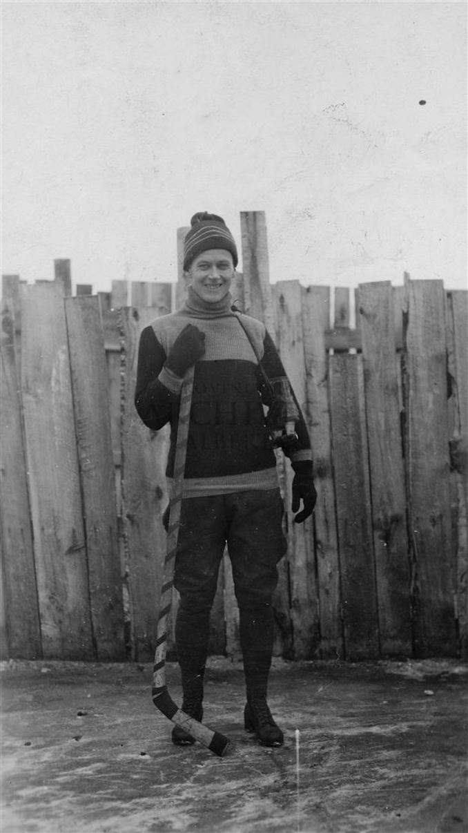 1920? - PR2009.0441.0059 - Allen Godby on ice rink with hockey stick, Mountain Park, Alberta