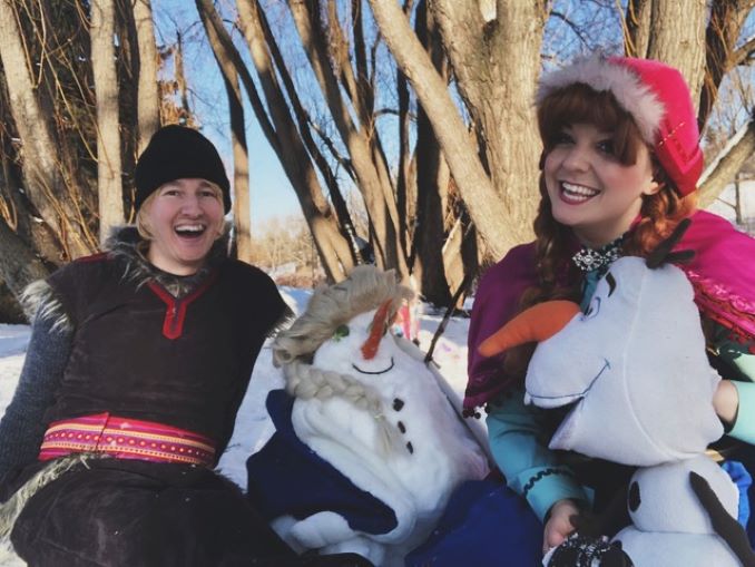 Caitlynne Medrek and Jordan Charette building a snowman with YYC Princess