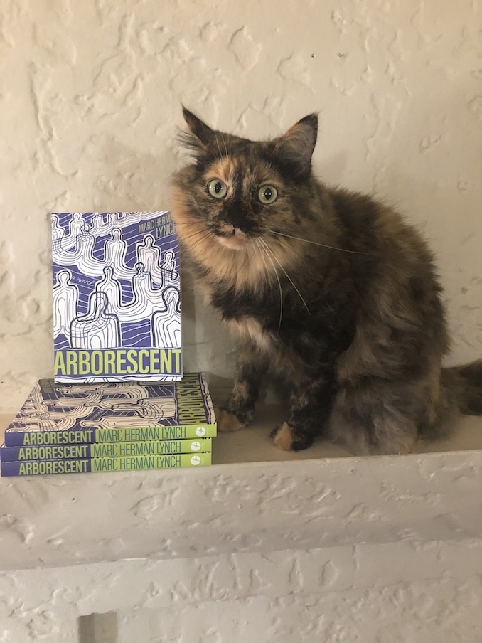 (Photo by Michaela Stephen) Banana Loaf posing next to my debut novel, Arborescent (Arsenal Pulp Press 2020). 