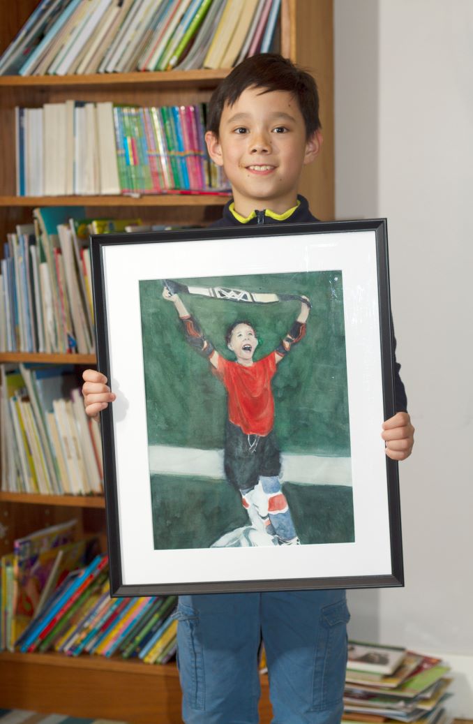 Phillip Matisse celebrating the time he won the Heart and Hustle award following a hockey game.