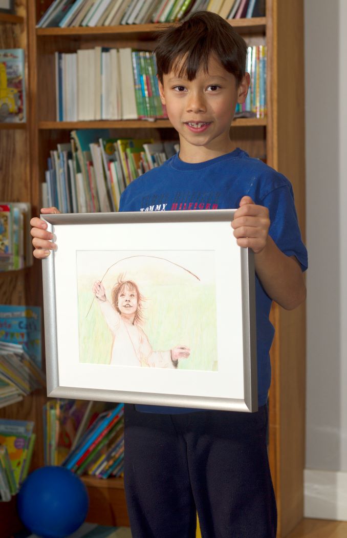 Phillip. Luka holding a portrait done when he was just a toddler.