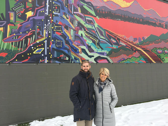 my son Justin in front of a mural I created for the North Glenmore Park Community Association.