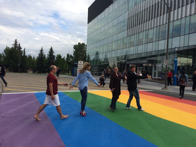 Natalie Meisner - Here is a picture of me and my wonderful colleagues/allies at MRU (yes, before covid) walking across the rainbow crosswalk. As an openly queer member of a bi-racial family I have felt supported and valued at MRU. Do I need to say more about our university as a home for diversity and our sense of fun? A picture is worth a thousand words. I am honoured to call these folks my colleagues and friends.