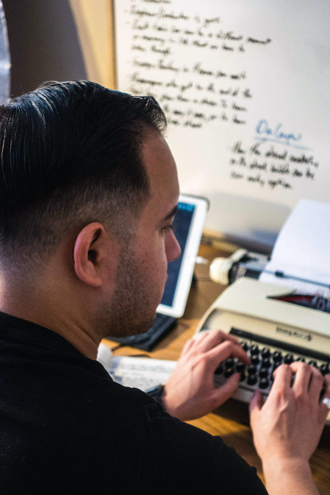 Hard at work, typing out another draft of a screenplay on the typewriter in the studio.