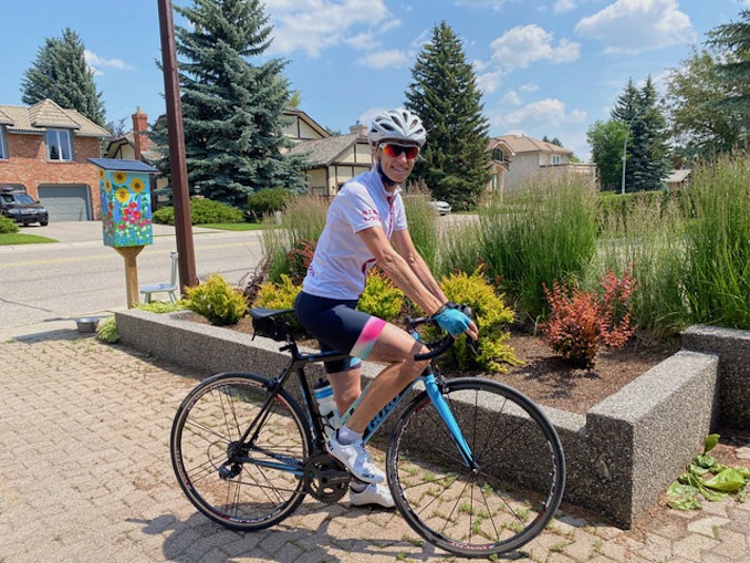 Getting ready for a bike ride. Note the Little Free Library I painted in the background.