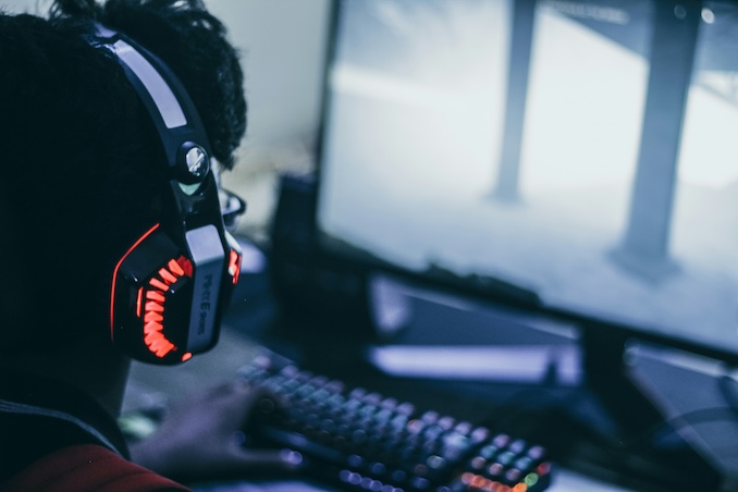 Guy playing video games on a computer.