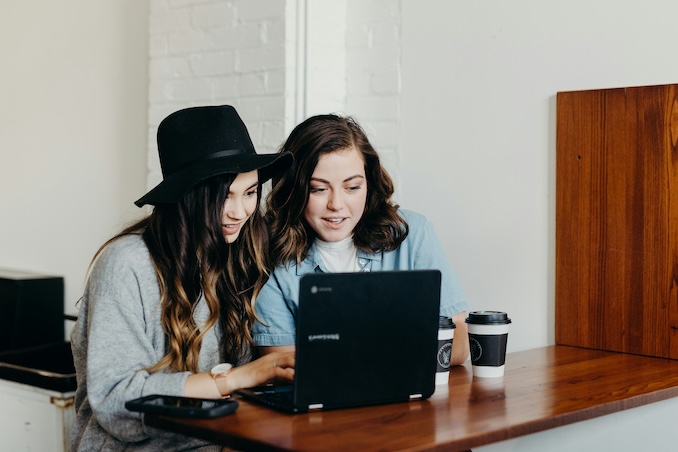 two women playing on the computer