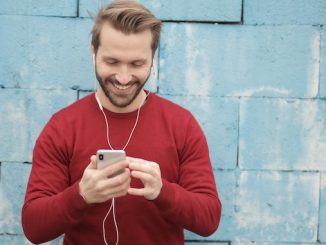 Photo by Andrea Piacquadio: https://www.pexels.com/photo/cheerful-young-man-listening-to-music-in-earphones-on-smartphone-on-street-near-wall-3966747/