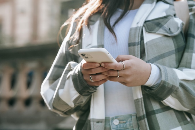 Woman using cellphone outside