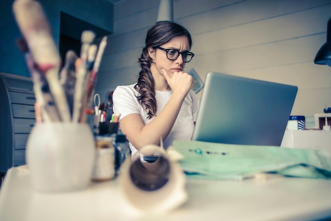 Woman looking concerned at her laptop