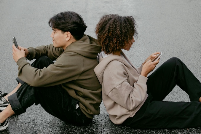 two friends texting on phones