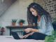 women in bed on laptop